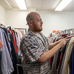 Hartwick College Alex Douglas, Civic Engagement Coordinator working the the clothing closet