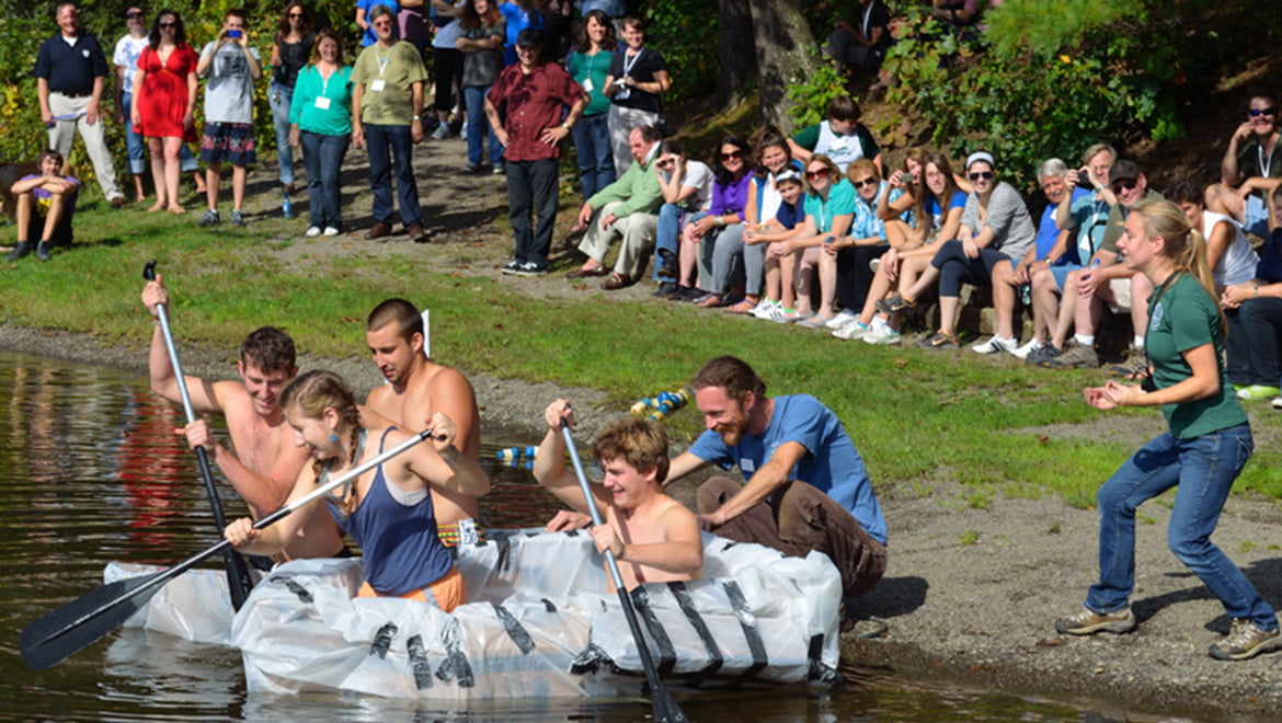 Hartwick College students in cardboard boat race at Pine Lake during True Blue Weekend