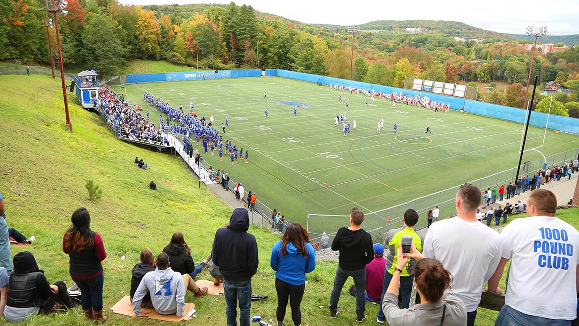 Hartwick College football fans watching game from hillside of Wright Stadium
