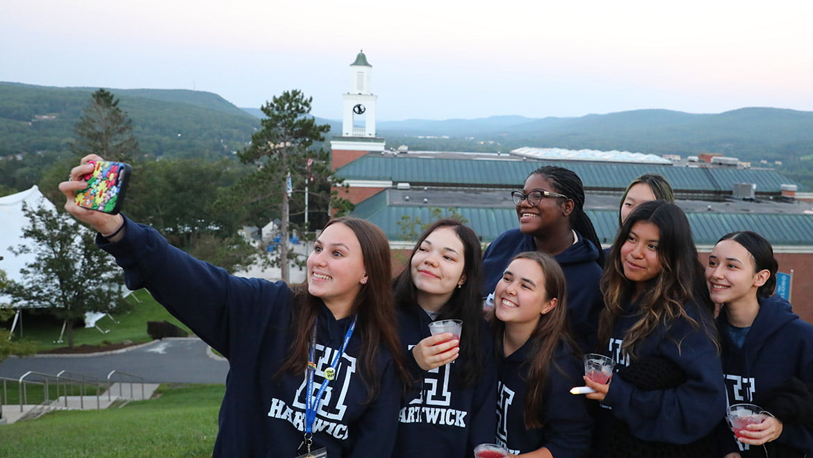 Hartwick College students gather for selfie photos after Class of 2027 First Walk on Founders' Way