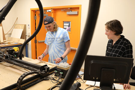 Hartwick College faculty mentor with art student working in the Fab Lab