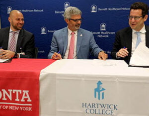 Dr. Tommy Ibrahim, President and CEO of Bassett Healthcare Network, SUNY Oneonta President Alberto Cardelle, Hartwick College President Darren Reisberg during the signing of the new Bassett CARES partnership agreement