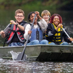 Hartwick College students boating at Pine Lake during True Blue Weekend