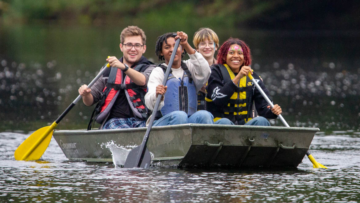 Hartwick College students boating at Pine Lake during True Blue Weekend