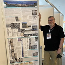 Hartwick College Professor of Geology and Department Chair David Griffing in front of conference research poster presentation