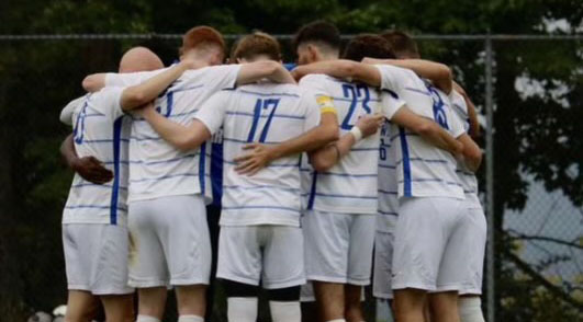 Hartwick College men's soccer team in huddle