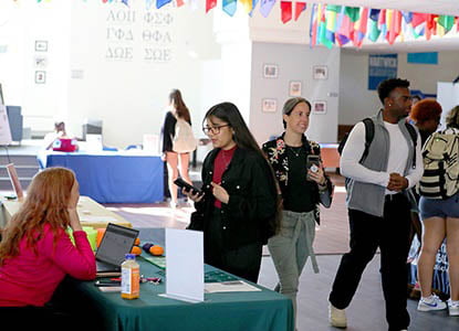 Hartwick College student talking with representative from Health & Social Services Industry Day program