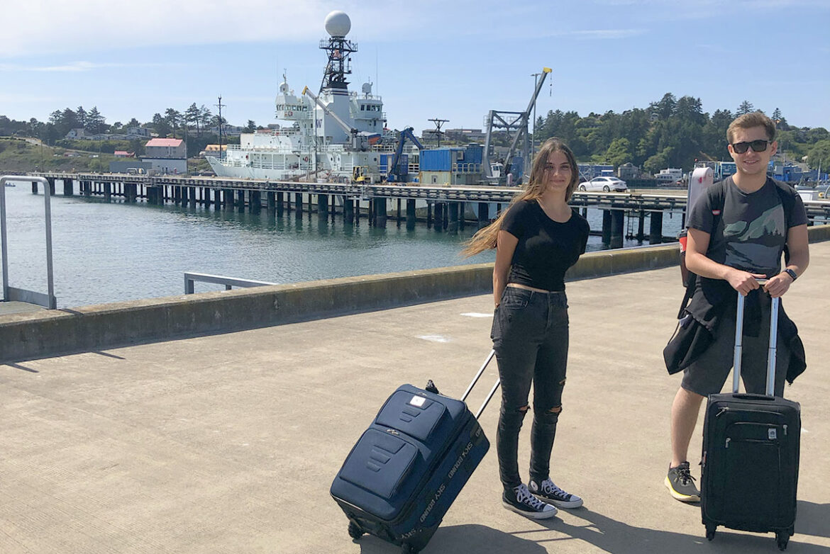 Students with suitcases ready to set sail on ship