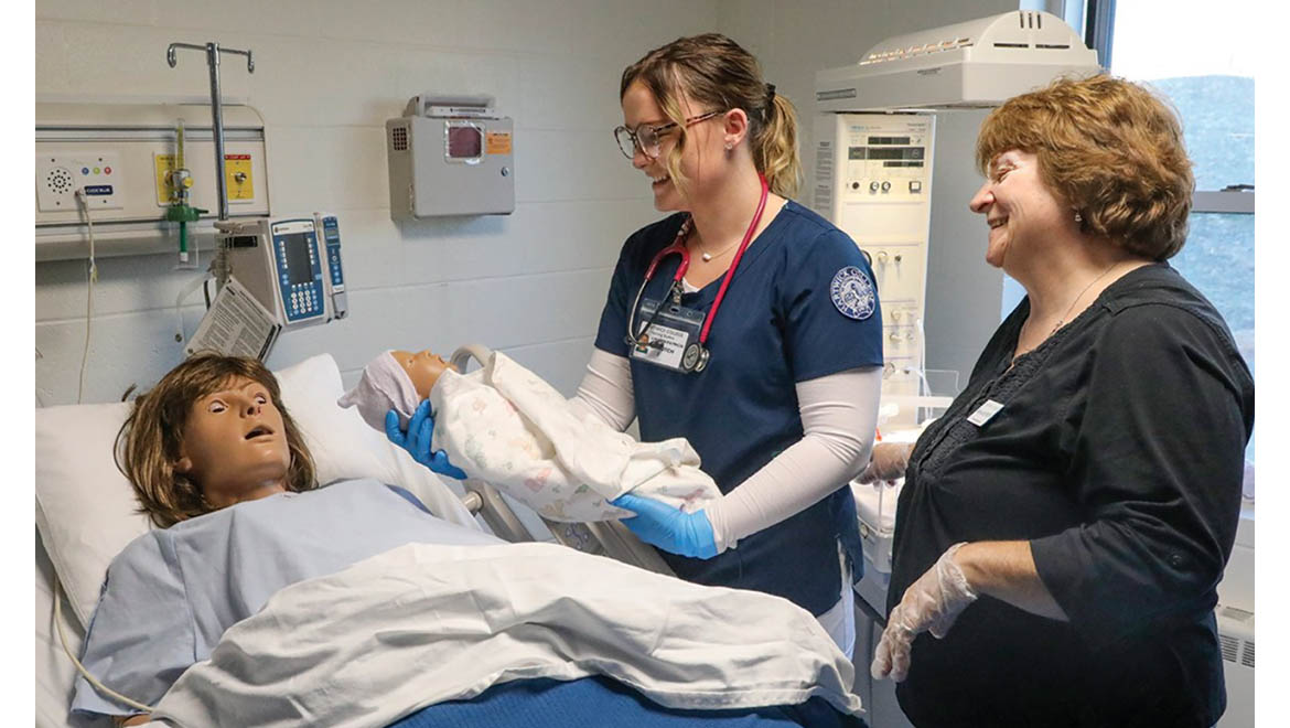 Hartwick College nursing student with faculty member in birthing simulation lab, 2019