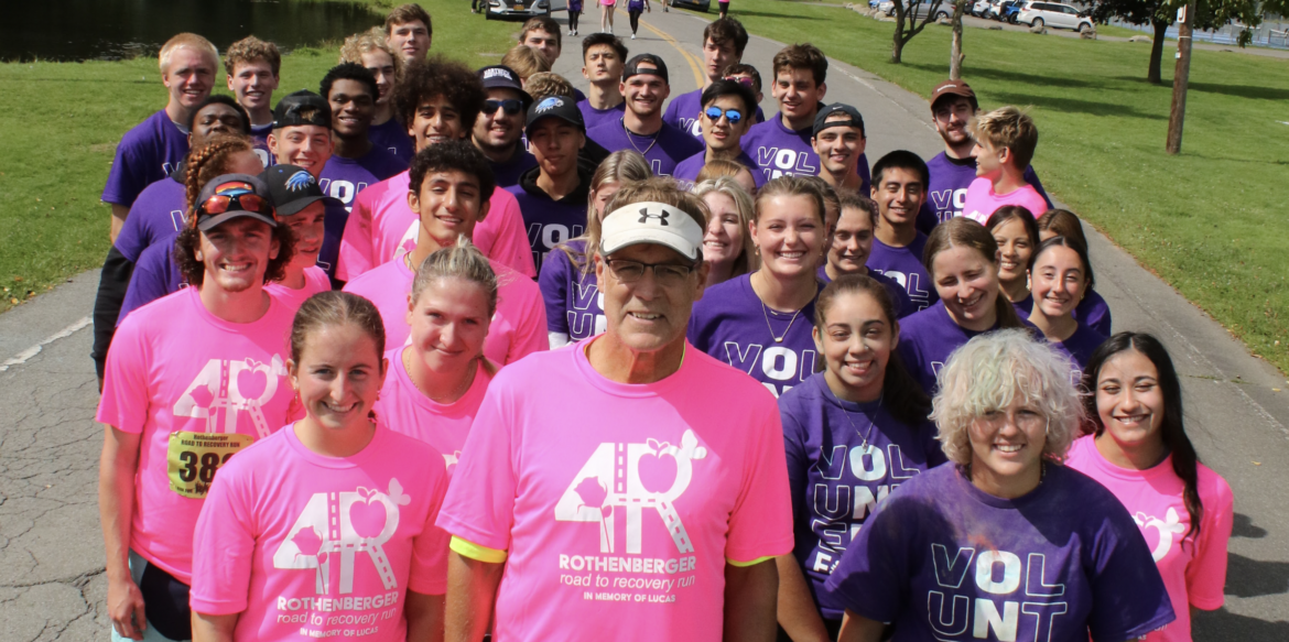 Hartwick College Coach Dale Rothenberger with group of students at 5k event