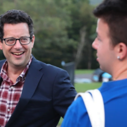President Reisberg laughs with students