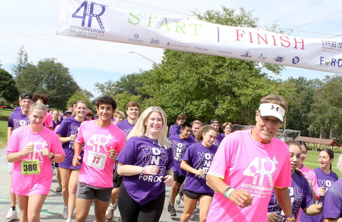 Hartwick College Coach Dale Rothenberger with group of students at 5k event