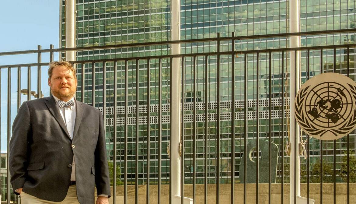 Hartwick College alumnus Ryan Smith in front of the United Nations building