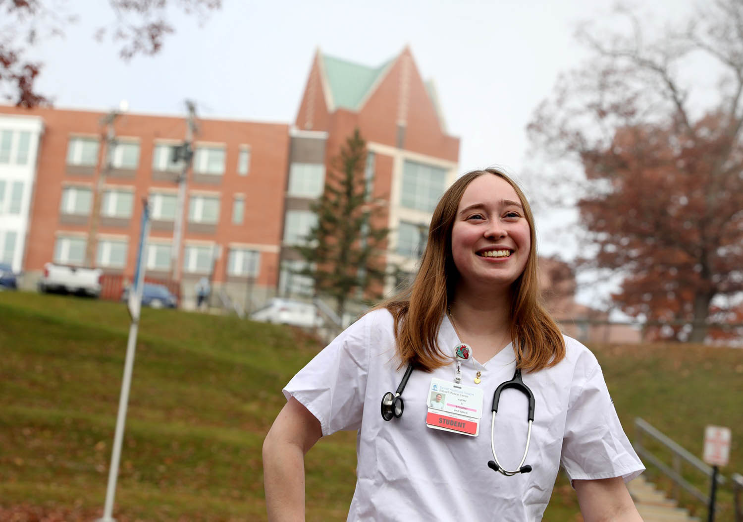 Hartwick College student with Johnstone Science Center in the background