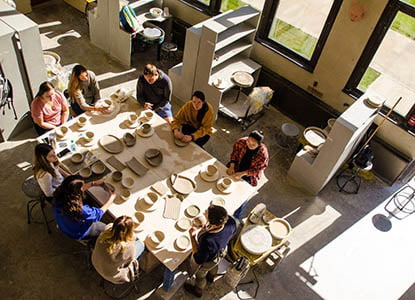 Hartwick College students and faculty in ceramics studio