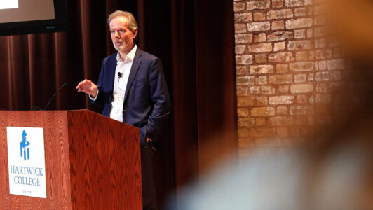 Mike McIntire speaking in Anderson Theater, Hartwick College