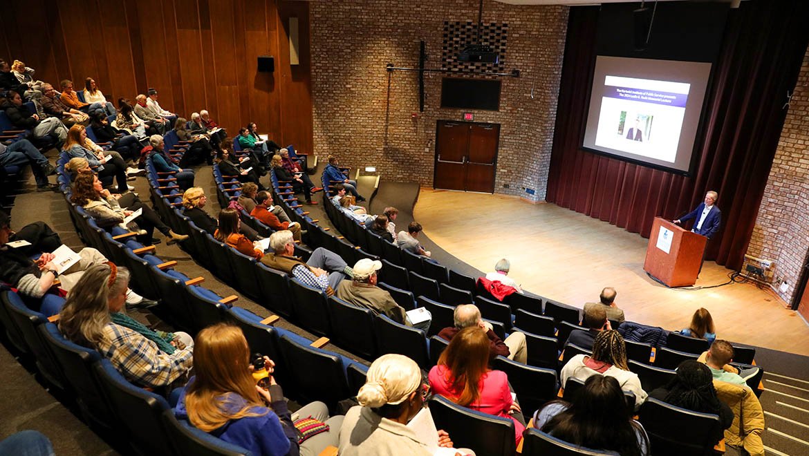 Mike McIntire speaking in Anderson Theater, Hartwick College