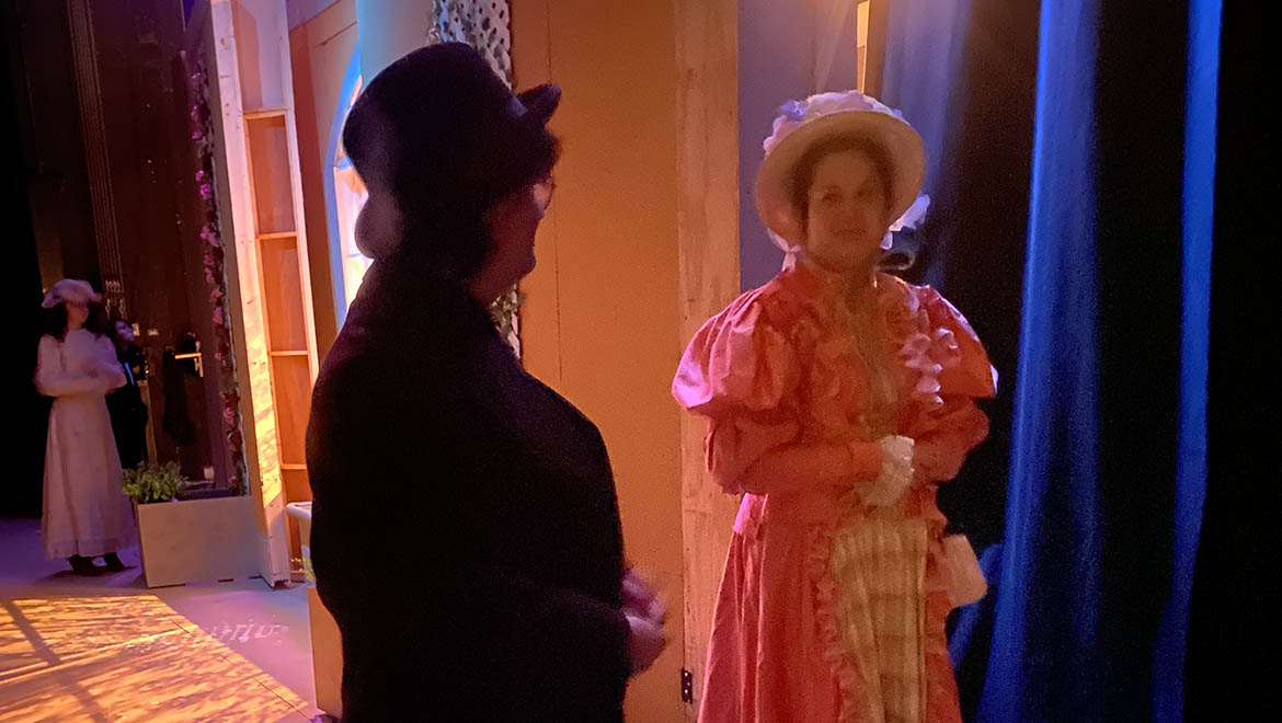 Hartwick theatre students in costume waiting in the wings backstage