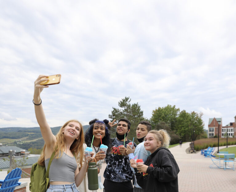 Hartwick College students taking a selfie on Founders' Way