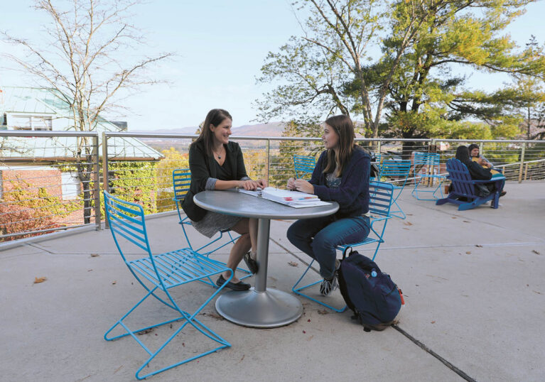 Hartwick College faculty member meeting with student outside on Founders' Way