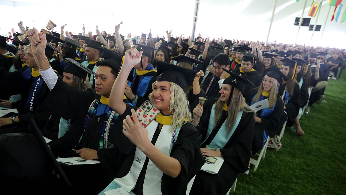 Hartwick College graduates ringing Hartwick bells during Commencement