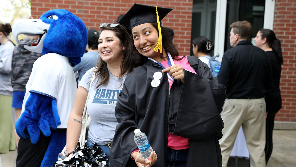 Graduate with Hartwick College Staff member after Last Walk on Founders' Way