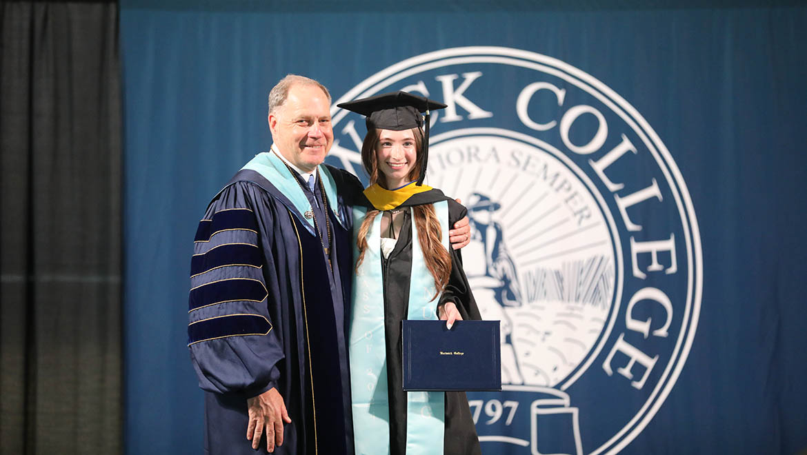 Hartwick College graduate being congratulated by Interim President Mullen