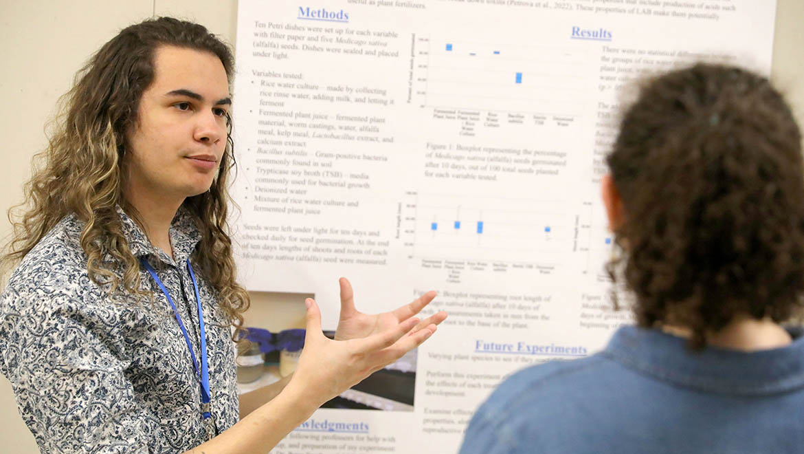 Hartwick College student presenting research poster during Student Showcase