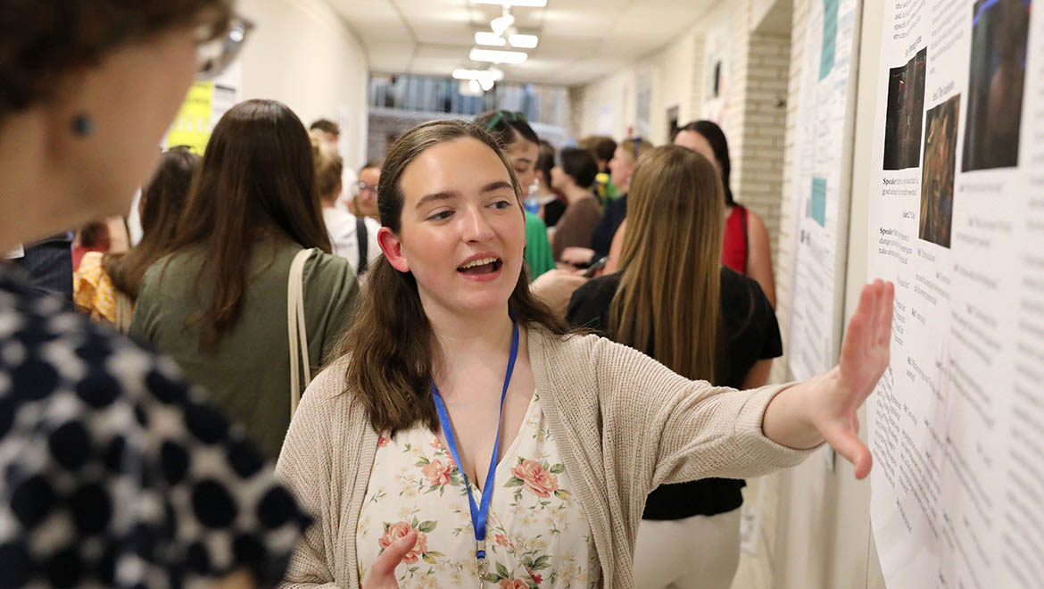 Hartwick College student presenting research poster during Student Showcase