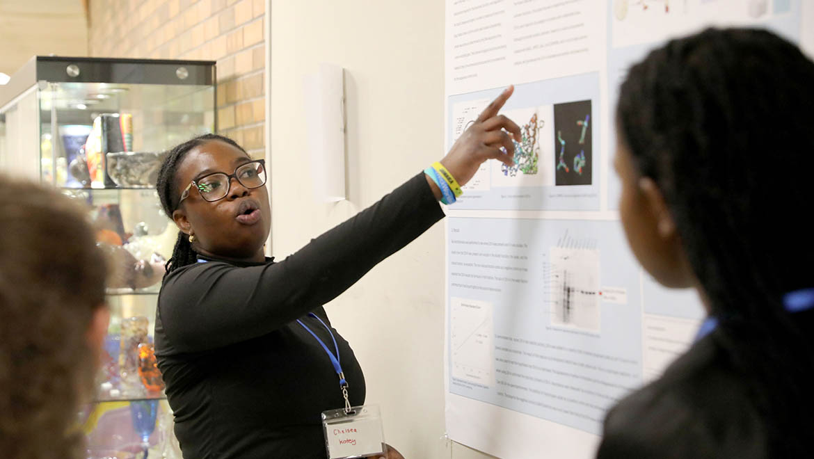 Hartwick College student presenting research poster during Student Showcase