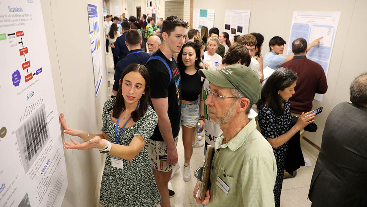 Hartwick College student presenting research poster during Student Showcase