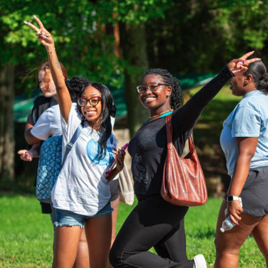 Hartwick College students smiling on campus