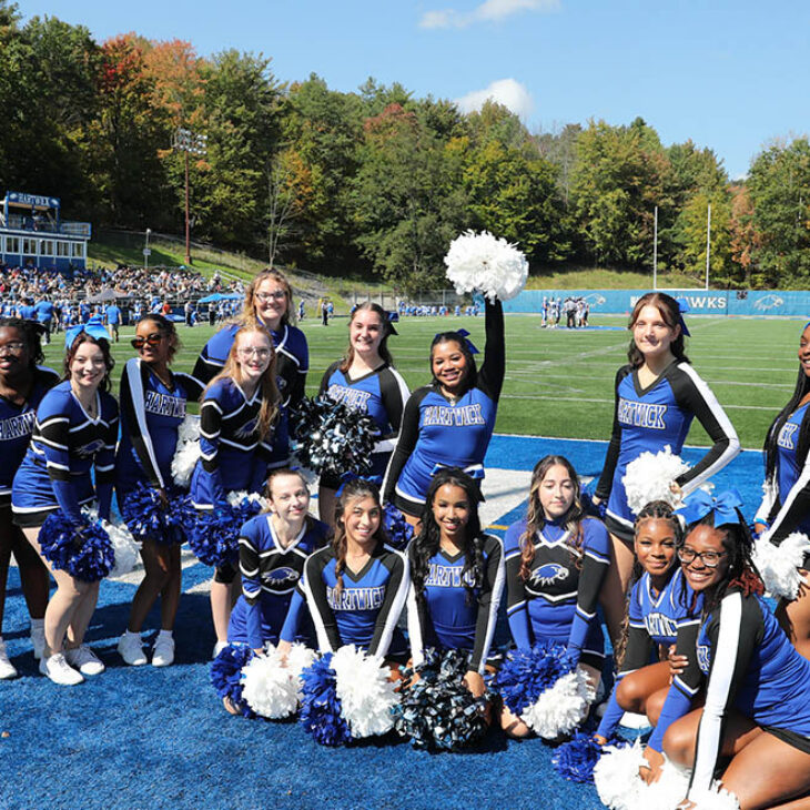 Hartwick College cheerleaders at football game during True Blue Weekend