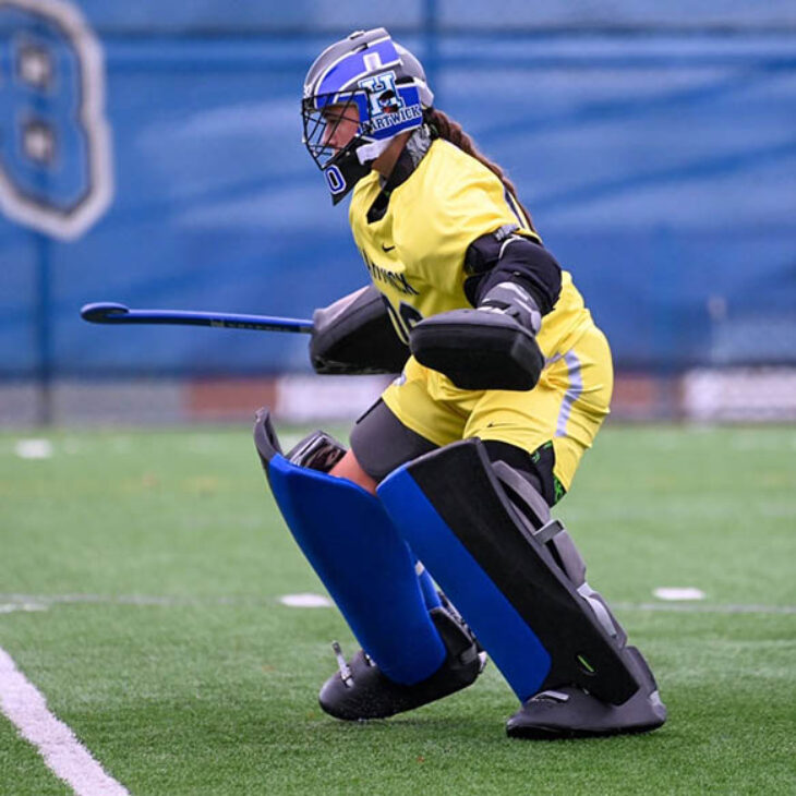 Ava Reynolds defending goal during field hockey game