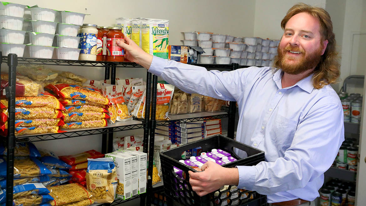 Tim Raimy '17 re-stocking campus food pantry