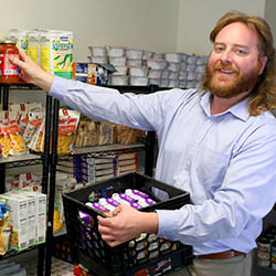 Tim Raimy '17 re-stocking campus food pantry