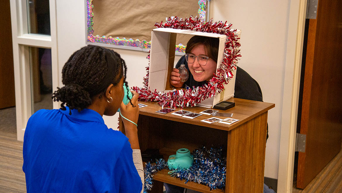 Blue Key Ambassadors taking photo for Holiday Party Project