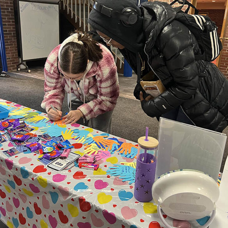Hartwick College students signing notecards during BERT Tabling Event in Commons Lobby, Dewar Union