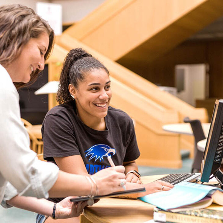 Hartwick College student with advisor in front of computer