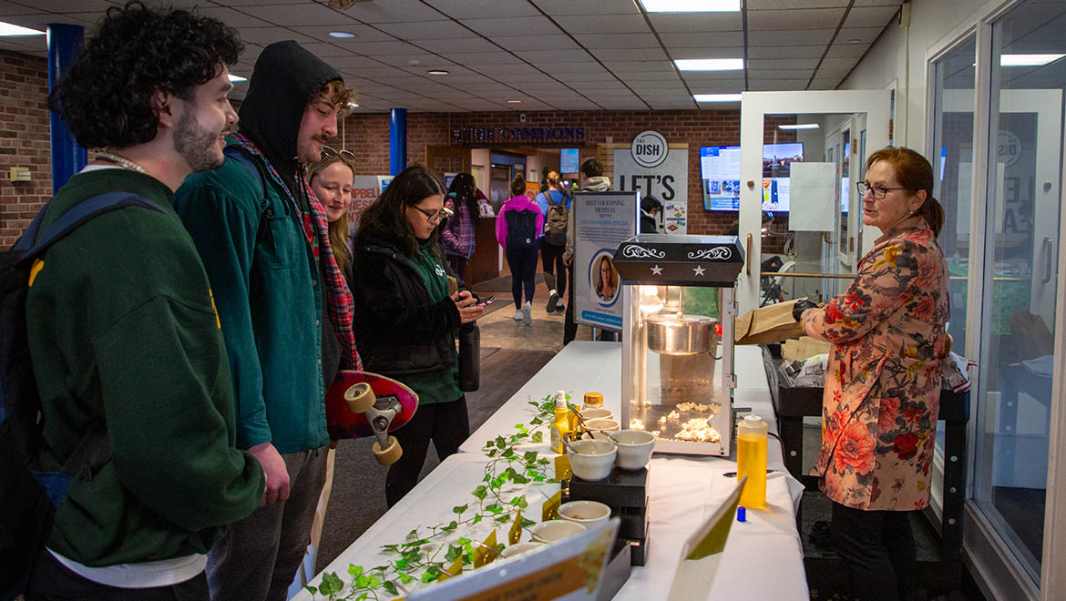 Dietitian Ruth Sullivan with Hartwick College students at healthy snack bar