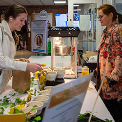 Dietitian Ruth Sullivan with Hartwick College student at healthy snack bar