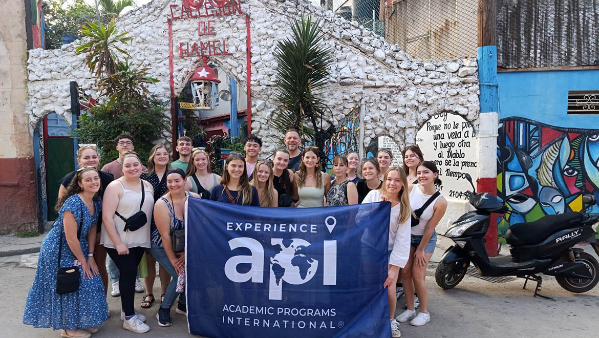 Hartwick College nursing students and staff in Cuba with api (Academic International Programs) banner