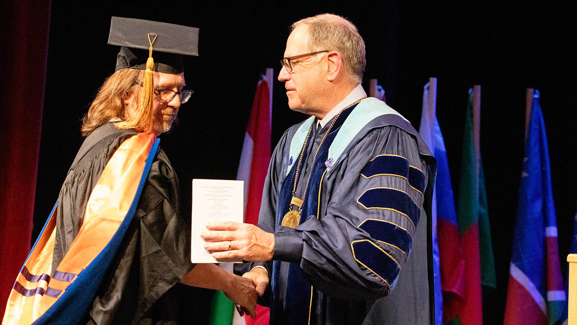 William Kowalczyk shaking hands with President Mullen