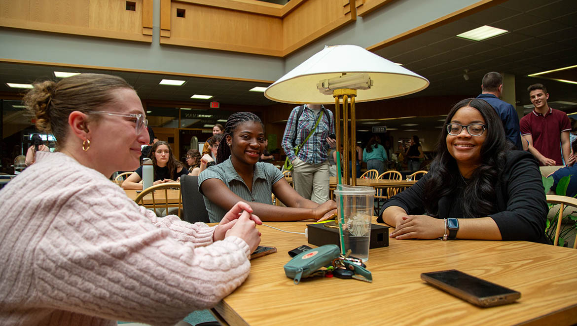 Hartwick College students at table in Stevens-German Library