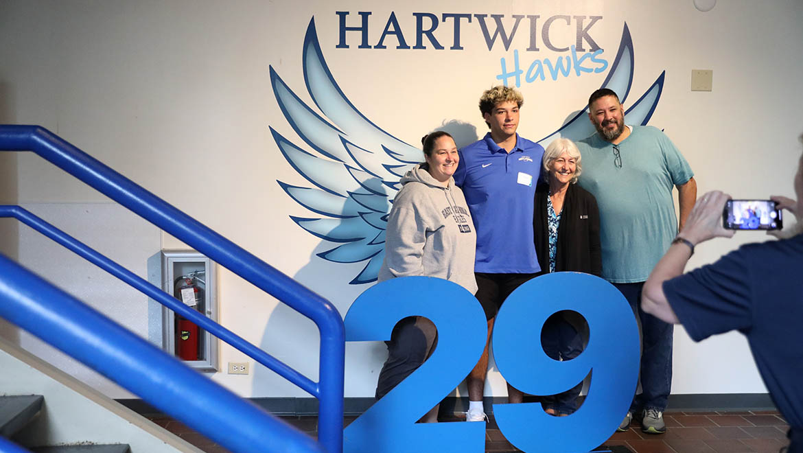 New Hartwick student with family posing for photos at Hartwick Hawks Wings, Stack Lounge, Dewar Union
