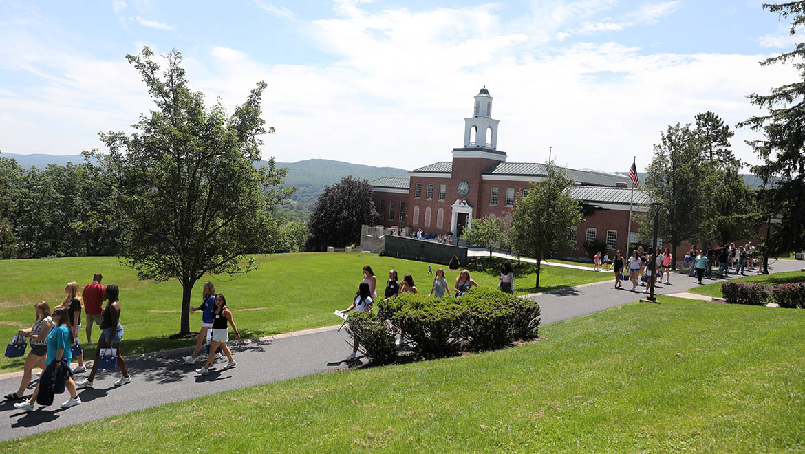 New Hartwick students walking on campus during Summer Orientation, Yager Hall in background