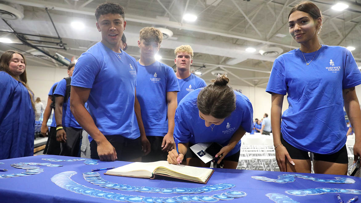 Hartwick College members of the Class of 2029 sign the Matriculation Book after Opening Convocation Ceremony