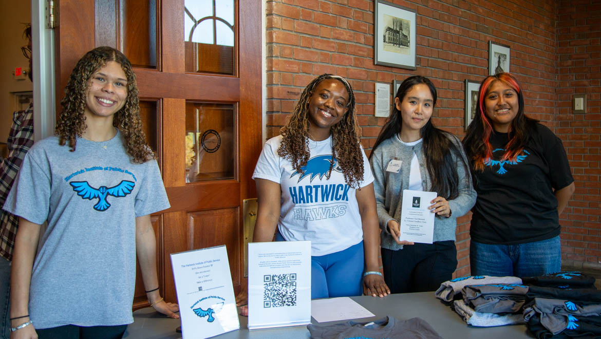 Hartwick College students of the Institute of Public Service at welcoming table before Constitution Day talk presented by Geoffrey Corn ’83, the George R. Killam Jr. Chair of Criminal Law and director of the Center for Military Law and Policy at Texas Tech University School of Law