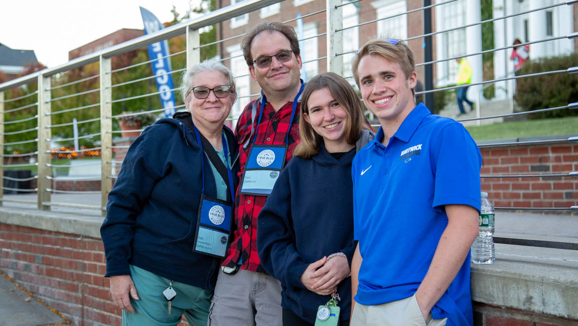 Hartwick College student with family on Founders' Way