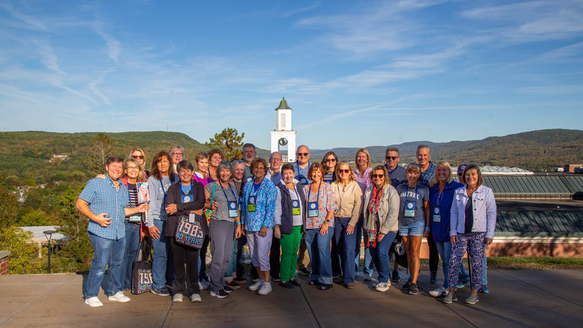Hartwick College alumni group photo on Founders' Way with Yager Hall Belltower in background
